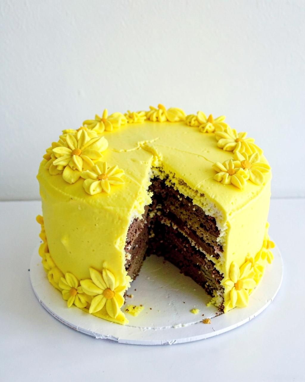 Yellow daisy cake with a slice cut out