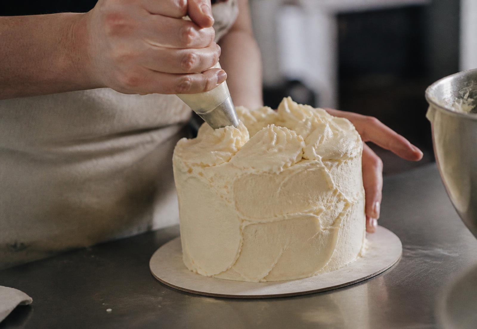 Cake being finished by hand